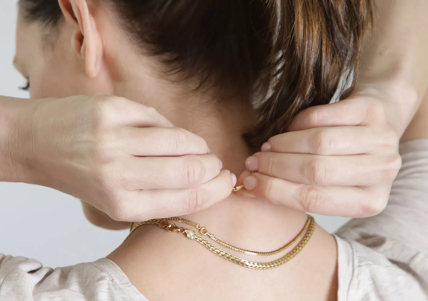 The Old-School Trick For Keeping Your Necklace In Place On Your Neck